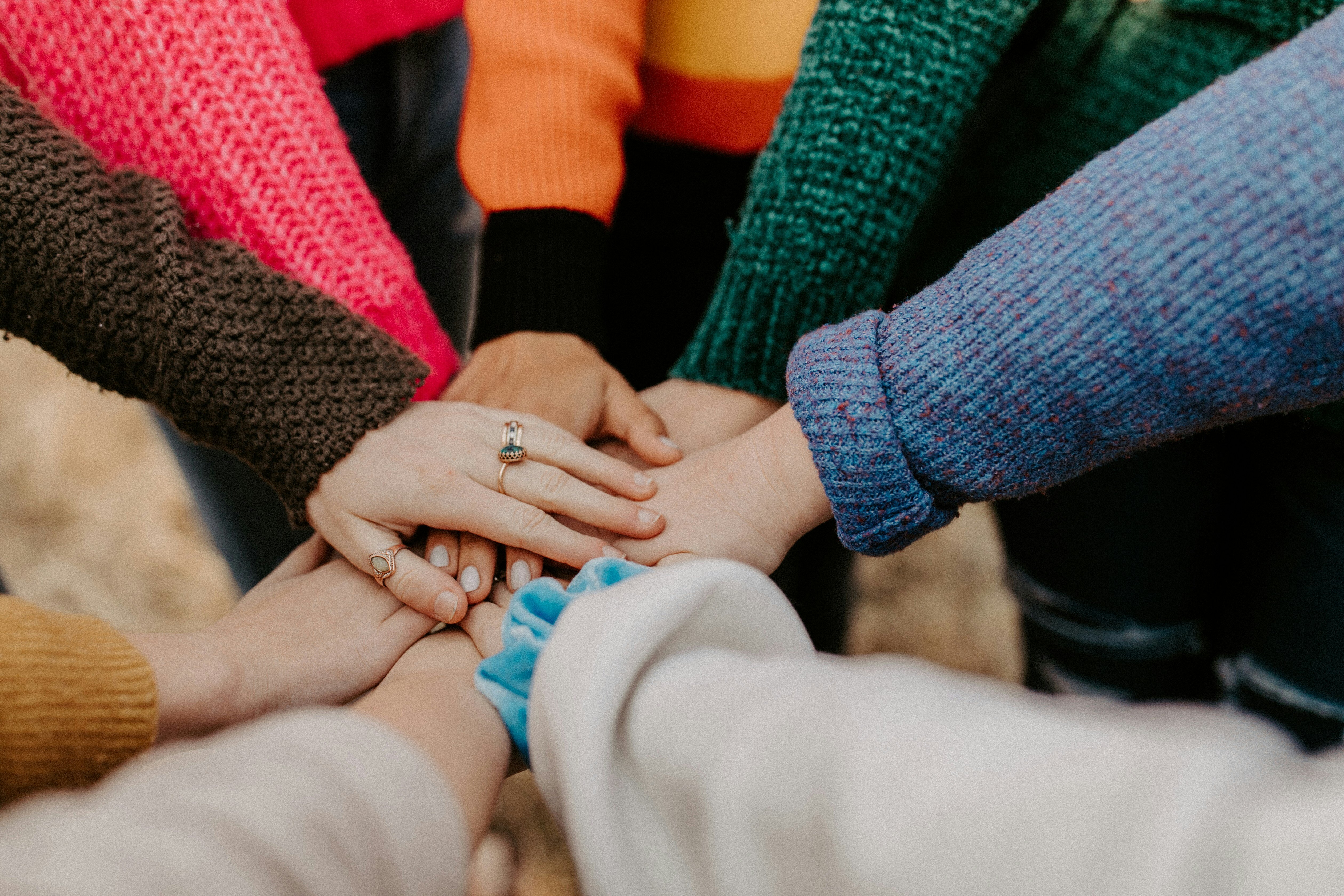 Many hands in a pile together